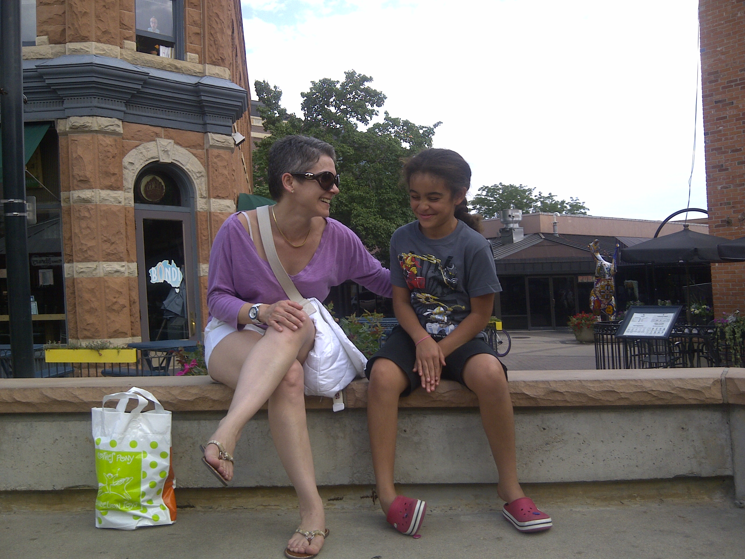 Mai and her daughter sitting together in Old Town Fort Collins